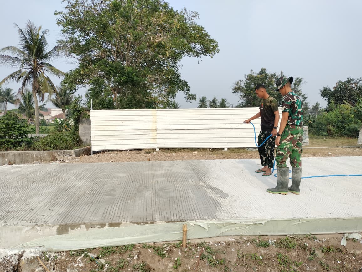 TNI TMMD Laksanakan Perawatan Jalan Dengan Penyiraman Beton Di Sumur Bandung